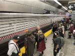 Passengers wait for the Holiday Arnine Set to pick them up at 96th St Station for the trip back to Midtown and the Lower East Side